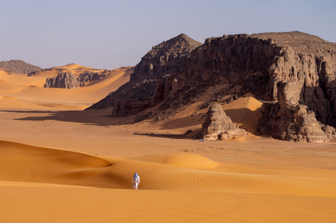 cz man in the middle of dunes in Sahara